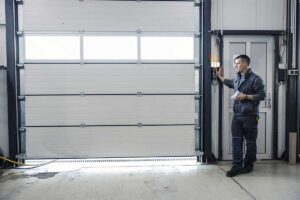 A garage door technician repairing a residential garage door.