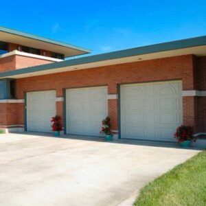 Three commercial garage doors on building